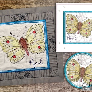 May include: Embroidered design of a yellow butterfly with red spots and the word "April" on a white background. The design is framed with a blue border and a black and gray border.