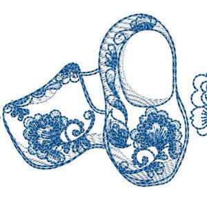 May include: An embroidered design featuring two blue clogs with floral patterns and two floral sprigs on a white background. The clogs are detailed with intricate stitching, showcasing a traditional folk art style.