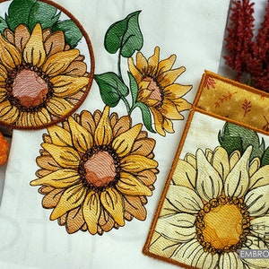 May include: A set of three embroidered kitchen towels featuring sunflowers in various shades of yellow, brown, and white. The towels have a rustic, farmhouse style and are perfect for adding a touch of warmth to your kitchen decor.