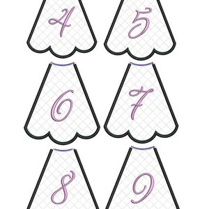 May include: Six white scalloped fabric shapes with pink numbers 4, 5, 6, 7, 8, and 9 embroidered on them.