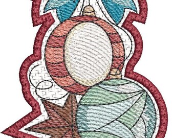 May include: Embroidered Christmas ornament featuring a blue bow, two round ornaments, and a star. The ornaments are red, green, and white, with a red border. The design is stitched on a white background.