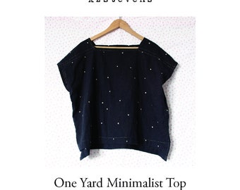 May include: A black, one-yard minimalist top with a square neckline and side splits. The top is decorated with white dots and is hanging on a wooden hanger. The text "One Yard Minimalist Top" is printed below the top. The text "copyright ©2021 karen stevens. all rights reserved. www.kzstevens.com" is printed below the text.