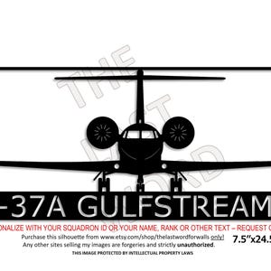 May include: Black silhouette of a C-37A Gulfstream V aircraft. The image includes the text "C-37A GULFSTREAM V" and the dimensions 7.5" x 24.5". The design is framed in a rectangular border.