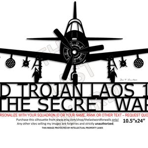 May include: Black metal silhouette of a T-28D Trojan aircraft with the text "T28D TROJAN LAOS 1967 THE SECRET WAR". The dimensions are 10.5" x 24".