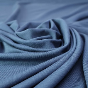 Flowy Bamboo Jersey Fabric in Lake Blue | Midweight, opaque knit fabric with fluid drape, subtle sheen, and 4 way stretch