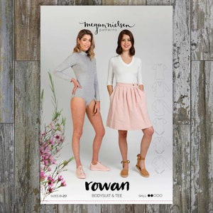 Może przedstawiać: Wzór szycia zatytułowany "Rowan Bodysuit & Tee" z dwoma modelkami w szarym body i białym topie z dekoltem w serek z różową spódnicą. Wzór zawiera opcje rozmiarów i wskaźniki poziomu umiejętności. Nazwa marki "Megan Nielsen Patterns" jest wyświetlana u góry.