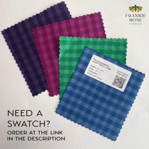 May include: Four fabric swatches in different colors: indigo, green, burgundy, and purple. Each swatch is a gingham pattern with a white background. The fabric is described as "Two-tone gingham tencel fabric | Indigo" with a weight of 6.0 oz/yd, a width of 59 inches, and a composition of 100% tencel lyocell. A QR code is included with the text "Scan Code to View Online".