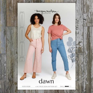 May include: Two women model a pair of jeans from the Dawn pattern set by Megan Nielsen Patterns. The pattern set includes four different styles of jeans, sizes 0-20. The women are wearing a pink and a blue pair of jeans.