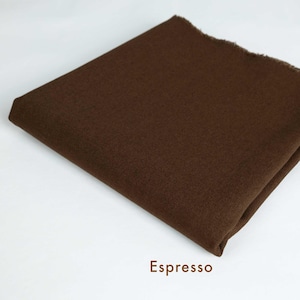 May include: A close-up of a brown fabric swatch. The fabric has a smooth, even texture. The swatch is labeled "Espresso".