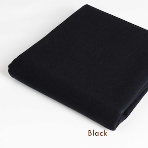May include: A black fabric swatch. The fabric is smooth and has a slight sheen.