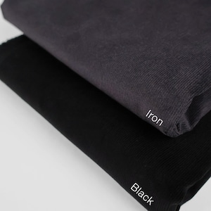 May include: Two fabric swatches, one black and one iron, with the color names written below each swatch.
