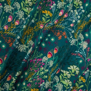 May include: A teal fabric featuring a dense botanical print of wildflowers in shades of yellow, white, magenta, and orange. The pattern consists of various stems, leaves, and blossoms arranged in a repeating, intricate meadow-inspired design.