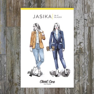 May include: A sewing pattern for a blazer called "Jasika" by Closet Core Patterns. The pattern shows two women wearing the blazer in different styles. One woman is wearing a brown blazer with blue jeans and a striped shirt. The other woman is wearing a blue blazer with matching pants.