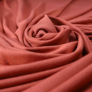 Flowy Bamboo Jersey Fabric in Marigold | Midweight, opaque knit fabric with fluid drape, subtle sheen, and 4 way stretch