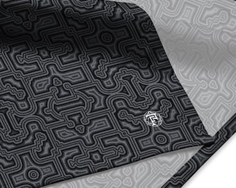 May include: Black and gray patterned fabric with a white border. The fabric has a geometric design and a small logo in the lower right corner.