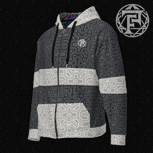 May include: A black and white zip-up hoodie with a geometric pattern. The hoodie has a black zipper and a black drawstring hood. The pattern is a repeating design of interlocking shapes.