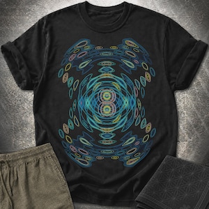 May include: A black short-sleeved t-shirt featuring a central graphic design composed of concentric, wavy, and oval-shaped lines in vibrant shades of blue, teal, yellow, and orange, creating a symmetrical, abstract, and fluid pattern across the chest.