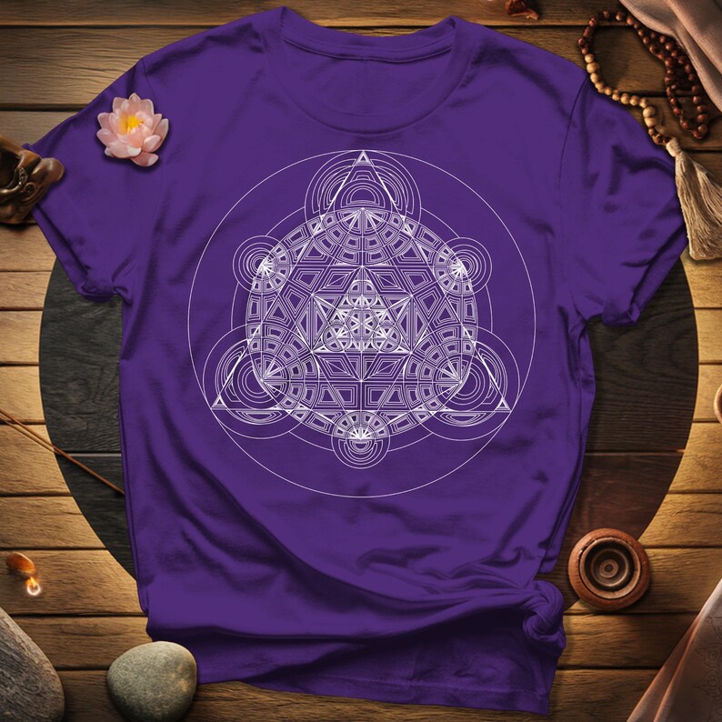 a purple t - shirt with a white design on it
