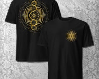 May include: Black t-shirts with gold geometric designs. One shirt features a small design on the chest, while the other has a large, intricate design on the back. The designs include circles, stars, and other geometric shapes.