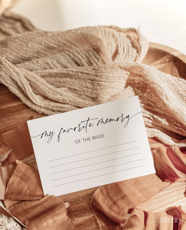 May include: A white card with the text "my favorite memory of the bride" written in black cursive. The card has lines for writing on it.