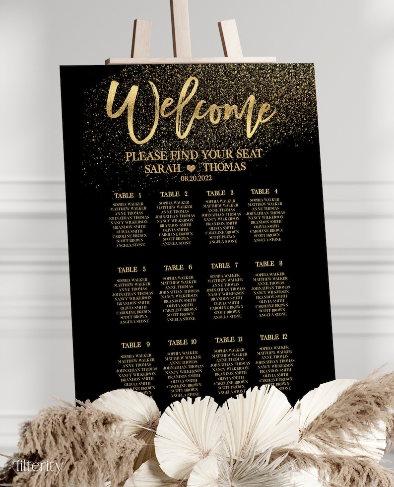 May include: A black and gold wedding seating chart with a glitter background. The chart lists the names of guests and their assigned tables. The text at the top reads "Welcome" and "Please find your seat Sarah & Thomas 08.20.2022".
