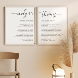 May include: Two framed art prints with black text on a white background. The left print says "carolyne" in cursive and includes a vow. The right print says "thomas" in cursive and includes a vow. Decorative wall art.