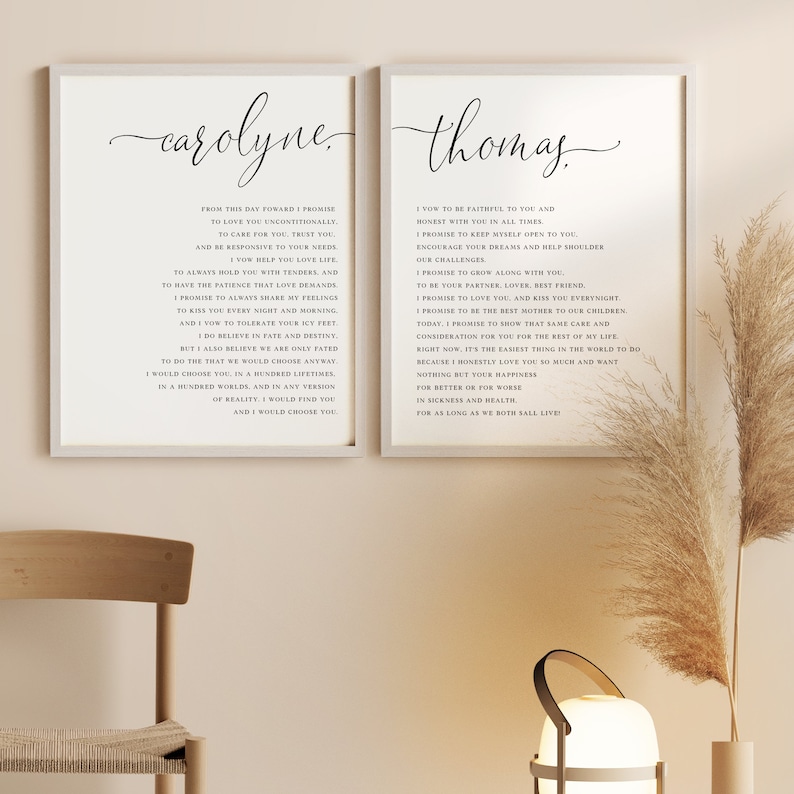 May include: Two framed art prints with black text on a white background. The left print says "carolyne" in cursive and includes a vow. The right print says "thomas" in cursive and includes a vow. Decorative wall art.