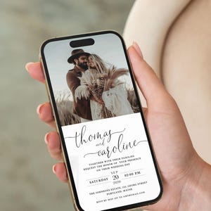 May include: A wedding invitation on a smartphone screen with a photo of a couple in the background. The invitation is for Thomas and Caroline's wedding on September 20, 2020, at 2:00 PM. The location is The Johnsons Estate, 125 Georg Street, Portland, Maine. RSVP by May 1st to amy@gmail.com.