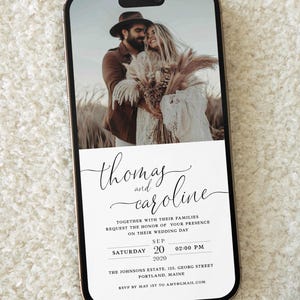 May include: A wedding invitation on a smartphone screen with a photo of a couple in a field. The invitation reads "Thomas and Caroline" with the date and time of the wedding: "Saturday, September 20, 2020 at 2:00 PM". The location is "The Johnsons Estate, 125 Georg Street, Portland, Maine". The RSVP information is "RSVP by May 1st to amy@gmail.com".