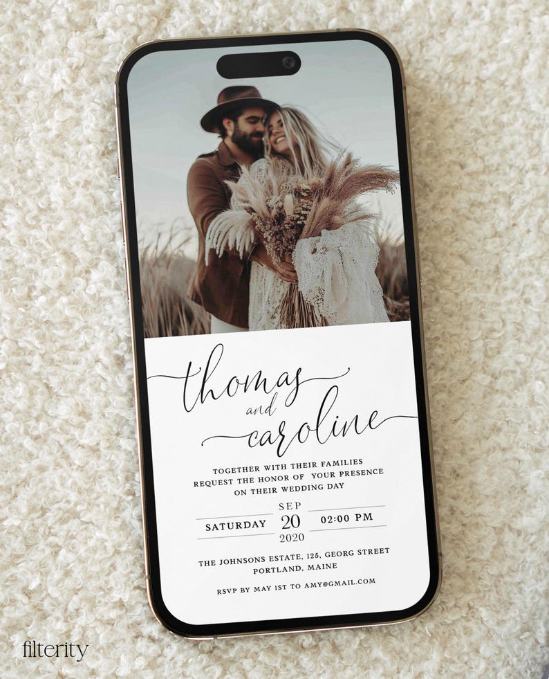 May include: A wedding invitation on a smartphone screen with a photo of a couple in a field. The invitation reads "Thomas and Caroline" with the date and time of the wedding: "Saturday, September 20, 2020 at 2:00 PM". The location is "The Johnsons Estate, 125 Georg Street, Portland, Maine". The RSVP information is "RSVP by May 1st to amy@gmail.com".