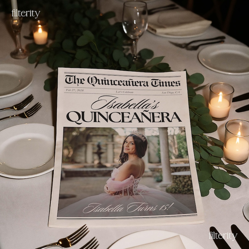May include: A newspaper titled "The Quincea&ntilde;era Times" with the headline "Isabella's Quincea&ntilde;era." The image features a young woman in a pink gown and tiara. The text "Isabella Turns 15!" is also visible. The newspaper is on a table with candles and greenery.