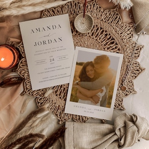 May include: A wedding invitation with a rustic theme. The invitation is printed on white cardstock with black text. The invitation includes the names Amanda and Jordan, the date June 24, 2027, and the time 6:00 PM. The invitation also includes the location of the wedding, The Johnsons Estate, 123 East Georg Street, Portland, Maine. The invitation is accompanied by a photograph of the couple.