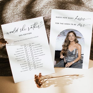 May include: Two white cards with black text for a bachelorette party game. One card reads "Would she rather?" and the other reads "Guess how many kisses for the soon-to-be Mrs." A woman in a silver sequin dress is in the background.