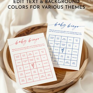 May include: Two printable baby bingo cards with a red heart in the center. The cards feature a variety of baby-related items, such as stuffed animals, socks, changing mats, hooded towels, bath toys, hats, car seats, pillows, bibs, pacifiers, bouncers, high chairs, gift cards, strollers, burp cloths, baby carriers, rattles, baby monitors, and baby spoons. The text on the cards reads "baby bingo" and "While the mom-to-be opens gifts, mark matching items on your card. The first person to get five in a row and shout 'Bingo' wins!"