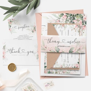 May include: Wedding invitation suite with a floral design featuring pink flowers and green leaves. The invitation includes a reception card, a thank you card, and a RSVP card. The text on the invitation reads "Thomas & Caroline" and "September 20, 2020".