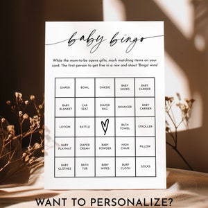 May include: A printable baby bingo card with a black and white design. The card has a 5x5 grid with squares containing baby-related items such as diapers, onesies, and rattles. The text "baby bingo" is written in cursive at the top of the card. The text "Want to personalize? Just edit the text!" is written at the bottom of the card.