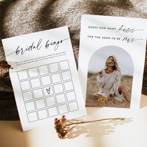 May include: A bridal shower game with a bingo card and a card that says "Guess how many kisses for the soon-to-be Mrs.". The bingo card has a heart in the center square.