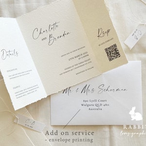 May include: A wedding invitation with a rustic, cream-colored paper texture. The invitation features the names "Charlotte and Brenden" in elegant cursive script. The text "Invite you to their wedding" is printed in black, along with the date, time, and location of the wedding. The invitation also includes a QR code for RSVP. The bottom of the invitation features the text "Mr. & Mrs. Scharmen" in cursive script, followed by their address and the text "RABBIT loves graphics".