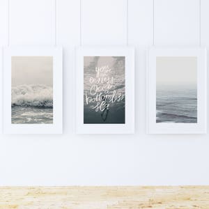 May include: Three framed prints with ocean scenes. The center print features a quote: "You are an endless ocean, a bottomless sea".