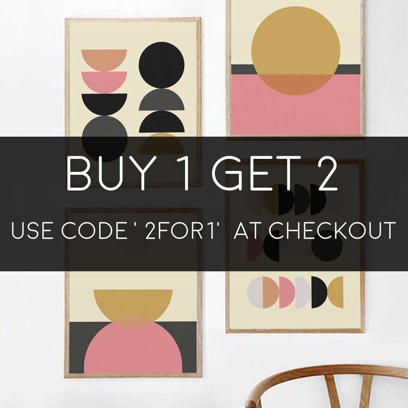 May include: Three framed abstract art prints with geometric shapes in black, gold, and pink. The prints are arranged in a row on a white wall. The text "BUY 1 GET 2" is displayed in black text on a white background. The text "USE CODE '2FOR1' AT CHECKOUT" is displayed in white text on a black background.