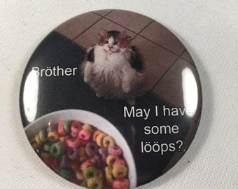 Kylskåpsmagnet med loop-motiv i kattform. "Broder, kan jag få några loopar?"