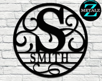 May include: Black metal monogram with the letter "S" and the name "SMITH" below. The monogram is surrounded by decorative swirls and is in a circular frame.