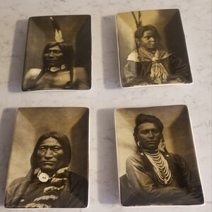May include: Set of four ceramic tiles featuring black and white photographs of Native American people. Each tile has a white border and a brown background.