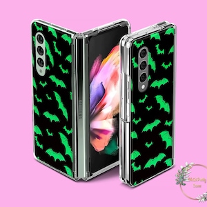 May include: A black phone case with a green bat pattern. The case is designed for a Samsung Galaxy Z Fold 4.