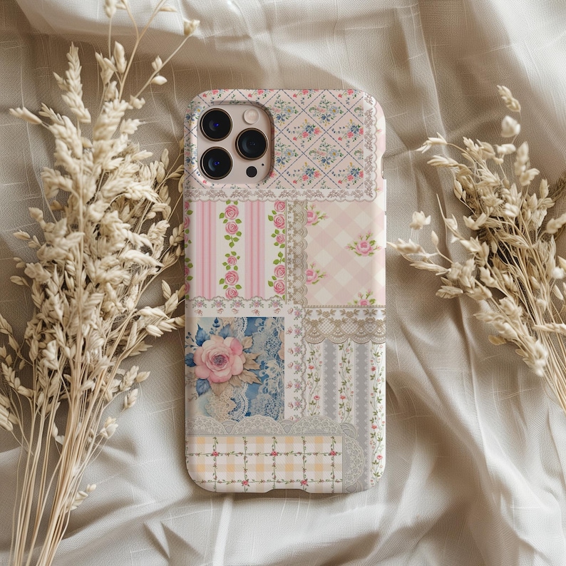 May include: A pink and white patchwork phone case with floral designs and lace accents. The case is made of durable plastic and features a cutout for the camera lens.