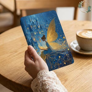 May include: A blue tablet case featuring a fairy illustration with golden wings, reading a book in front of a castle. The artwork has a whimsical, fantasy theme with gold accents and a starry night sky.