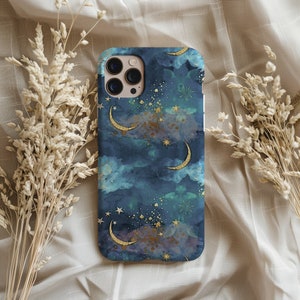 May include: A blue and gold phone case with a moon and stars pattern. The case has a watercolor effect and features gold glitter accents.