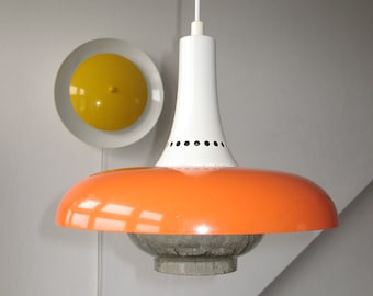 May include: A white and orange pendant light with a white, round, ceiling fixture. The pendant light has a white, bell-shaped top and a large, orange, circular bottom.