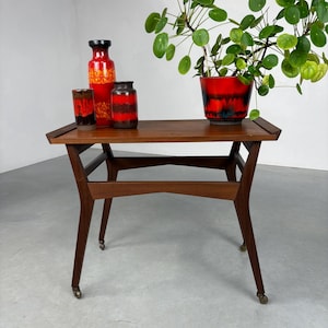 vintage wooden table with teak veneer on metal wheels - 1970s Scandinavian mobile side table