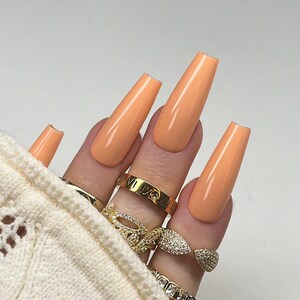 Peaches • Custom Nails By Nailzsy. Nail Artist. Hand-painted Press-on Gel Nails. Salon Quality. Square. Almond. Coffin. Orange. Simple.